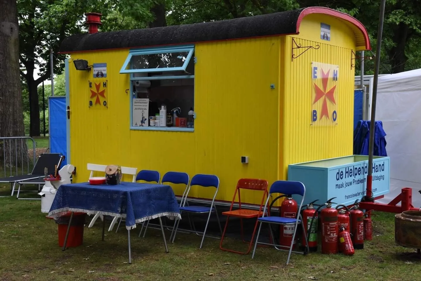 De gele hulpverleningswagen met EHBO-post op een evenement